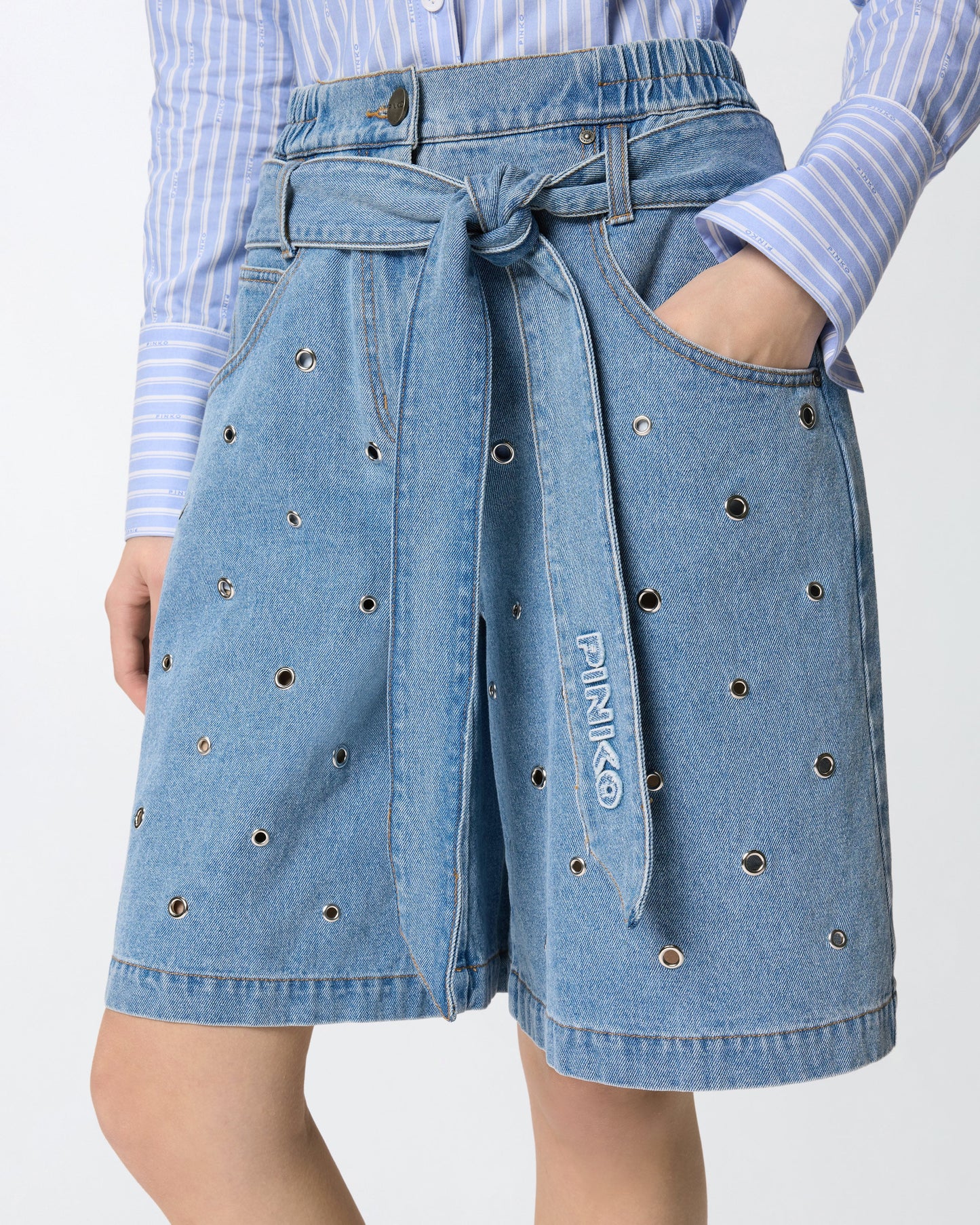 Denim shorts with eyelets and belt