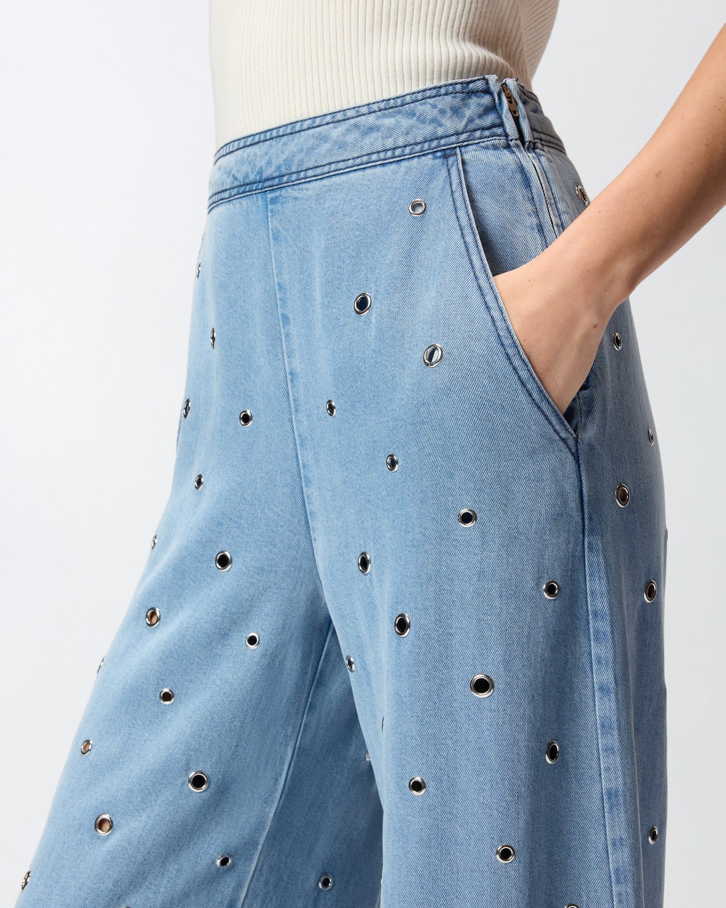 Denim jeans with eyelets